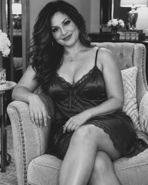Hispanic woman sitting on a couch.